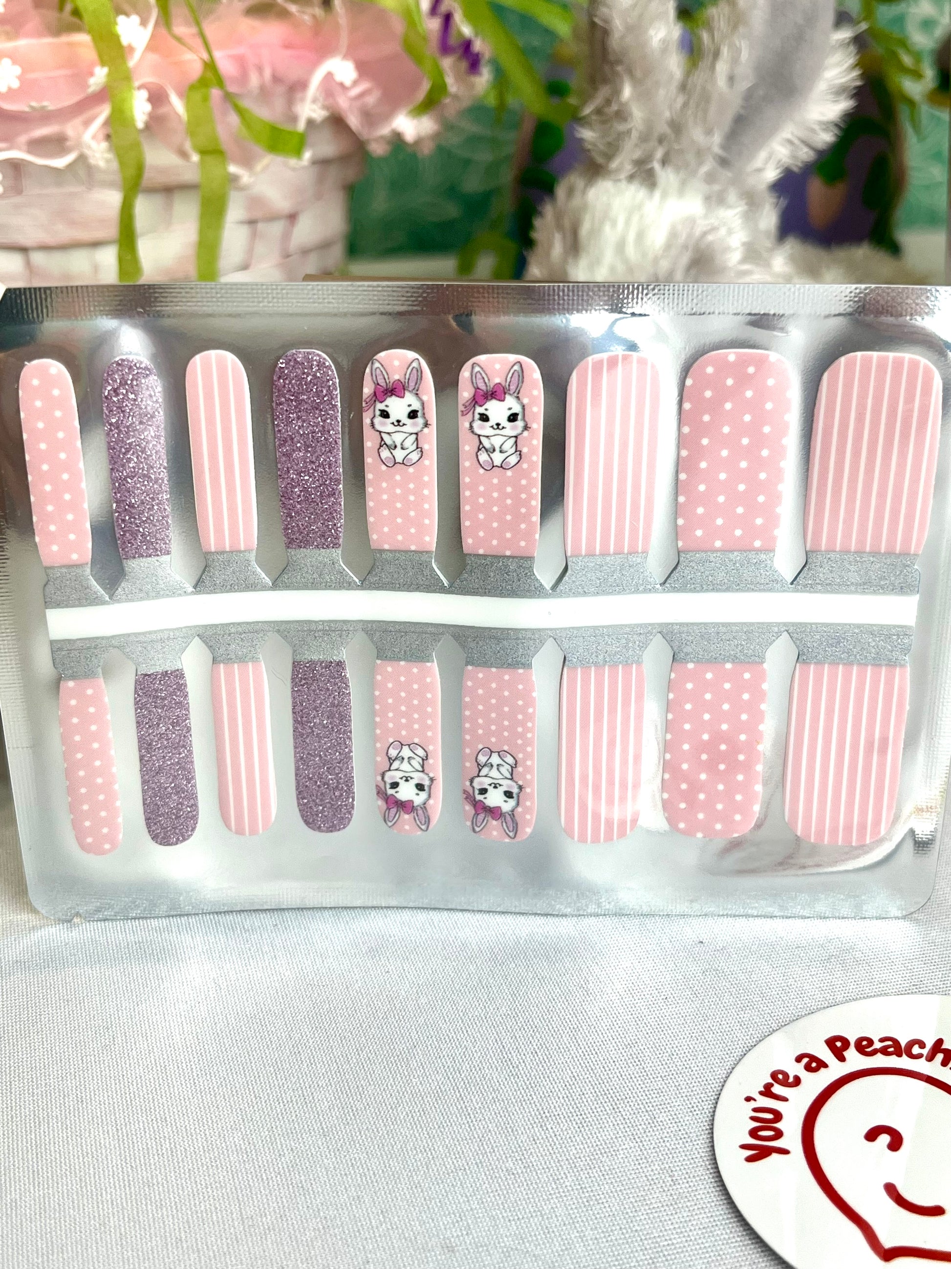Pink nail wraps with cute bunny, polka dot, stripe, and glitter designs